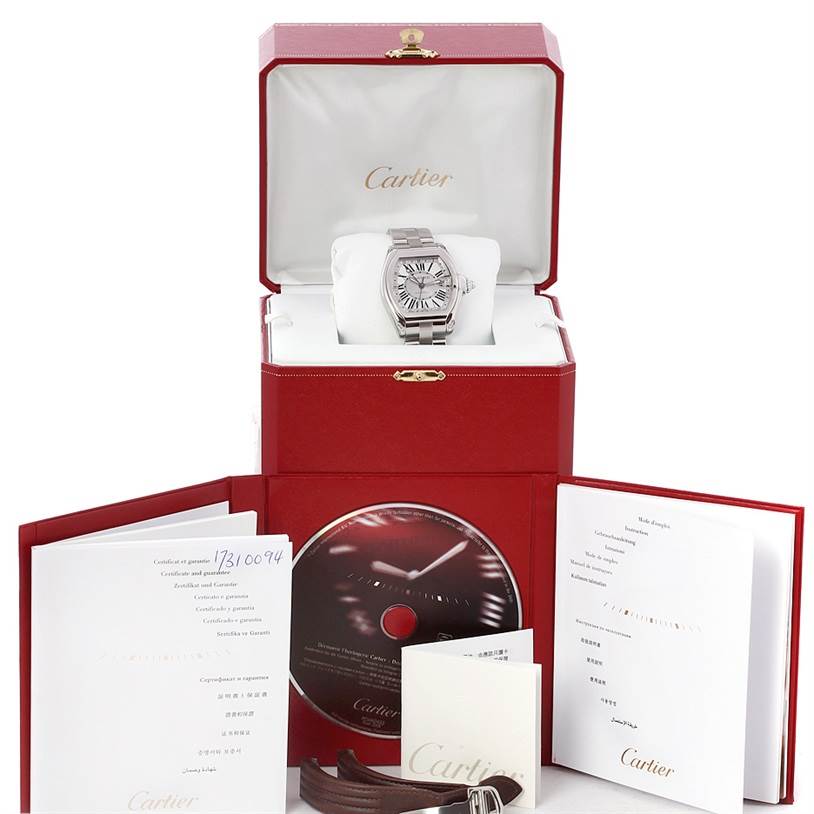 This Cartier Roadster W62032X6 Men's Stainless Steel Silver Dial W62032X6 Men's Stainless Steel Silver Dial watch is shown from a top angle with its box, manual, certificate, CD, and an extra strap.