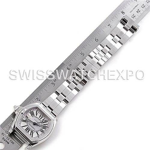 The image shows a Cartier Roadster W62032X6 Men's Stainless Steel Silver Dial W62032X6 Men's Stainless Steel Silver Dial watch laid flat next to a ruler, displaying its face and metal bracelet.