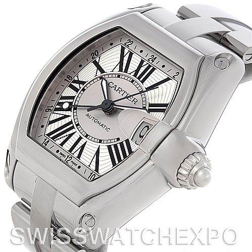 The image shows a closeup angled view of the Cartier Roadster W62032X6 Men's Stainless Steel Silver Dial W62032X6 Men's Stainless Steel Silver Dial watch, highlighting its face, crown, and part of the bracelet.