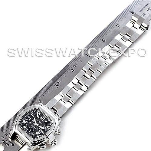 The image shows a top-down view of a Cartier Roadster W62020X6 Men's Stainless Steel Black Dial W62020X6 Men's Stainless Steel Black Dial watch, displaying its face and full bracelet alongside a measuring scale.