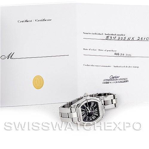 The image shows a Cartier Roadster W62041V3 Men's Stainless Steel Black Dial W62041V3 Men's Stainless Steel Black Dial watch and its certificate of authenticity from an overhead perspective.