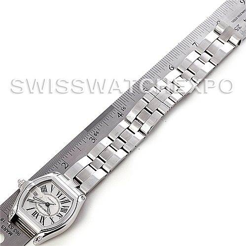 The Cartier Roadster W62025V3 Men's Stainless Steel Silver Dial W62025V3 Men's Stainless Steel Silver Dial watch is shown from a top-down angle, displaying the case, dial, and metal bracelet alongside a ruler for scale.