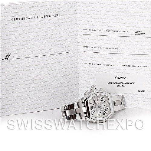 This image shows the Cartier Roadster W62019X6 Men's Stainless Steel Silver Dial W62019X6 Men's Stainless Steel Silver Dial watch facing front, alongside its certificate with visible text.