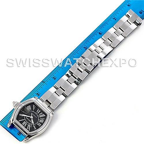 The image shows a Cartier Roadster W62041V3 Men's Stainless Steel Black Dial W62041V3 Men's Stainless Steel Black Dial watch laid flat with its strap extended next to a blue measuring ruler.