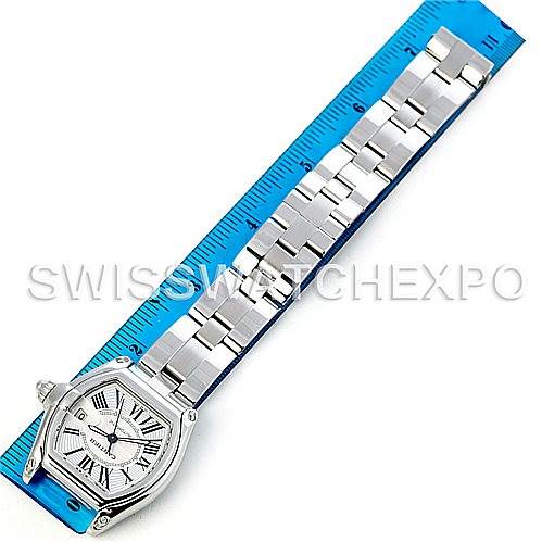 This image shows the top view of a Cartier Roadster W62025V3 Men's Stainless Steel Silver Dial W62025V3 Men's Stainless Steel Silver Dial watch with its band placed along a blue ruler for measurement.