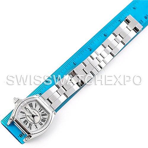 This image shows a Cartier Roadster W62025V3 Men's Stainless Steel Silver Dial W62025V3 Men's Stainless Steel Silver Dial watch from a top-down angle, including its bracelet and part of a blue measuring ruler.