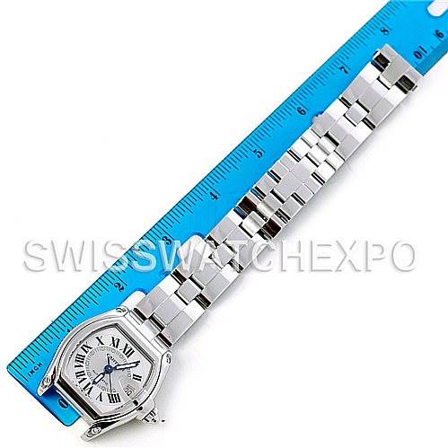 The image shows a top-down view of a Cartier Roadster W62025V3 Men's Stainless Steel Silver Dial W62025V3 Men's Stainless Steel Silver Dial watch, displaying its face, bracelet, and part of the clasp next to a ruler for scale.