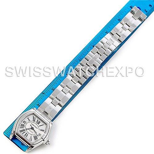 The Cartier Roadster W62025V3 Men's Stainless Steel Silver Dial W62025V3 Men's Stainless Steel Silver Dial watch is shown from a top-down angle, displaying the entire bracelet and face alongside a blue measuring ruler.
