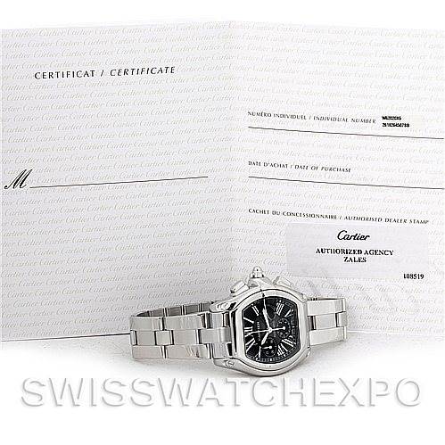 The image shows a Cartier Roadster W62020X6 Men's Stainless Steel Black Dial W62020X6 Men's Stainless Steel Black Dial watch with a stainless steel bracelet at a slight angle with its certificate and documentation.