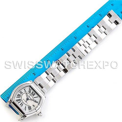 The image shows the face and bracelet of a Cartier Roadster W62025V3 Men's Stainless Steel Silver Dial W62025V3 Men's Stainless Steel Silver Dial model watch next to a blue ruler for scale.