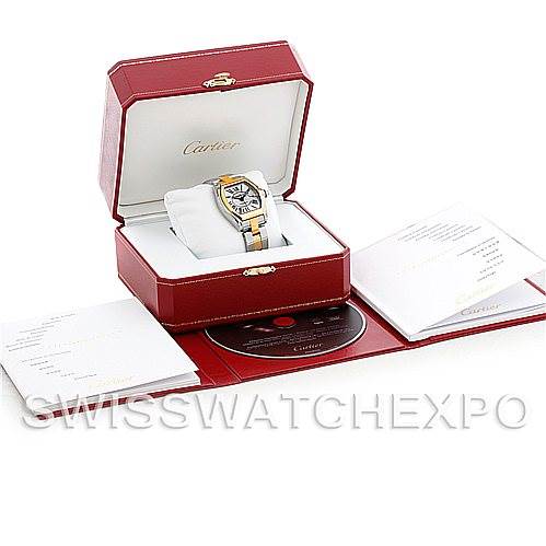 The Cartier Roadster W62031Y4 Men's Steel and Gold (two tone) Silver Dial W62031Y4 Men's Steel and Gold (two tone) Silver Dial watch is shown in its opened box, along with booklets and a disc.