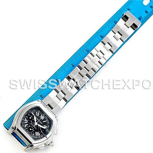 The image shows a Cartier Roadster W62020X6 Men's Stainless Steel Black Dial W62020X6 Men's Stainless Steel Black Dial watch laid flat with a ruler for measurement, displaying the watch face and band.