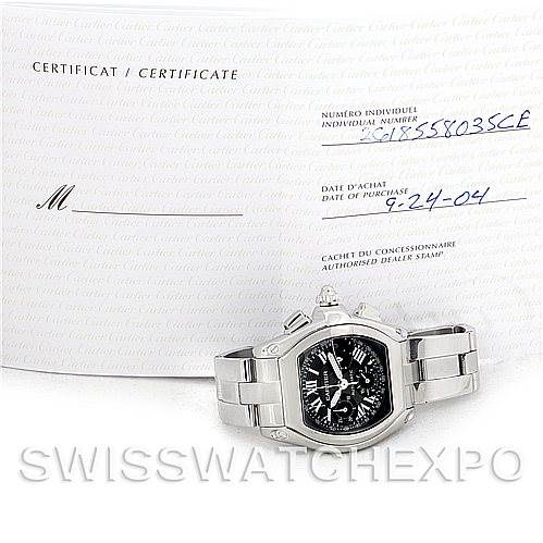The image shows a Cartier Roadster W62020X6 Men's Stainless Steel Black Dial W62020X6 Men's Stainless Steel Black Dial watch from the front, with accompanying certifications in the background.