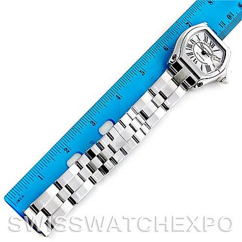 The image shows a Cartier Roadster W62025V3 Men's Stainless Steel Silver Dial W62025V3 Men's Stainless Steel Silver Dial watch placed next to a blue ruler, showcasing the watch face and entire metal bracelet.