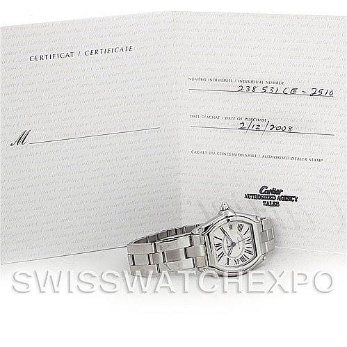 The Cartier Roadster W62025V3 Men's Stainless Steel Silver Dial W62025V3 Men's Stainless Steel Silver Dial watch is displayed alongside its certification papers, showing the face, bracelet, and part of the crown.