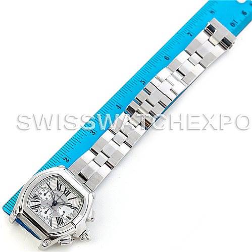 This image shows the Cartier Roadster W62019X6 Men's Stainless Steel Silver Dial W62019X6 Men's Stainless Steel Silver Dial watch lying flat with a ruler next to it to demonstrate size.