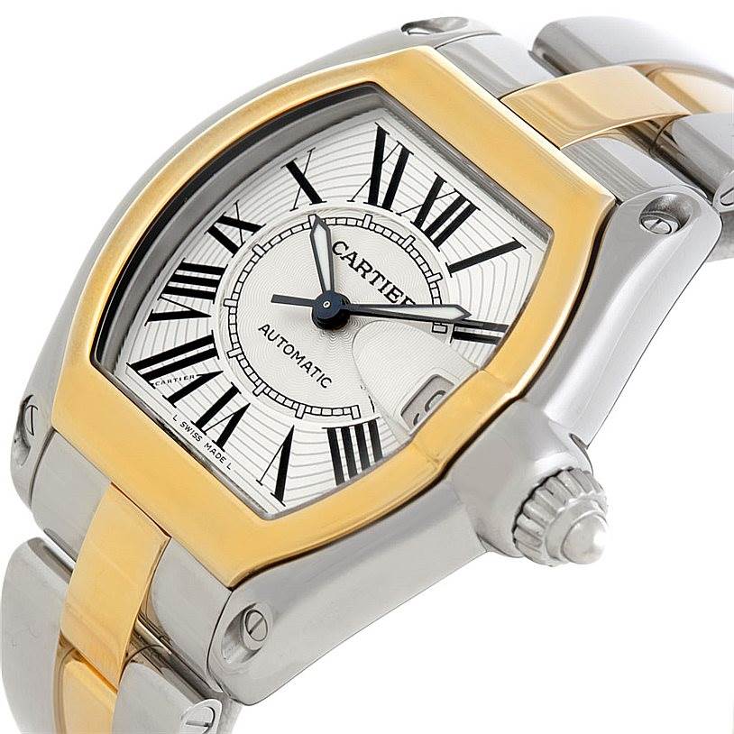 This image shows a Cartier Roadster W62031Y4 Men's Steel and Gold (two tone) Silver Dial W62031Y4 Men's Steel and Gold (two tone) Silver Dial watch viewed from an angle highlighting the face, bezel, crown, and part of the bracelet.