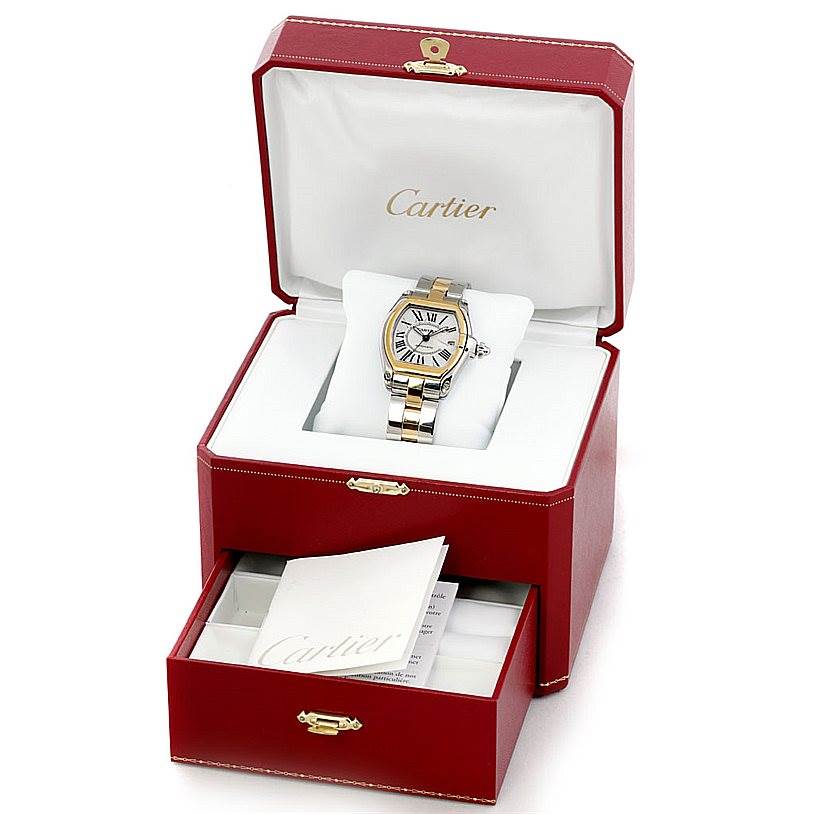 The Cartier Roadster W62031Y4 Men's Steel and Gold (two tone) Silver Dial W62031Y4 Men's Steel and Gold (two tone) Silver Dial watch is displayed in an open red box with an open drawer containing booklets.