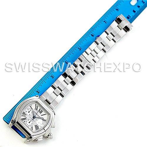 This image shows a Cartier Roadster W62019X6 Men's Stainless Steel Silver Dial W62019X6 Men's Stainless Steel Silver Dial watch laid flat next to a blue ruler for size reference.