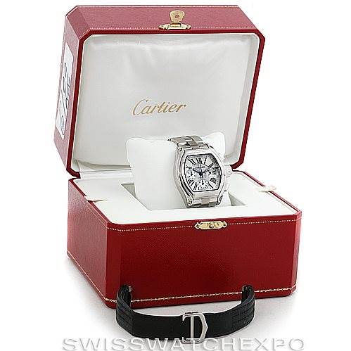 The Cartier Roadster W62019X6 Men's Stainless Steel Silver Dial W62019X6 Men's Stainless Steel Silver Dial watch is displayed at a front angle in its original red case, with an additional black strap beside it.