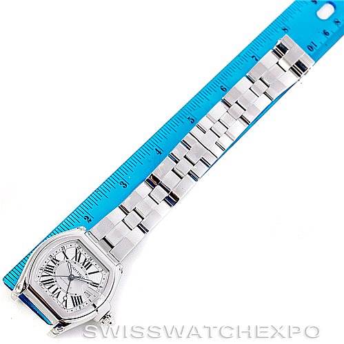The Cartier Roadster W62032X6 Men's Stainless Steel Silver Dial W62032X6 Men's Stainless Steel Silver Dial watch is shown from a top-down angle, displaying the face, case, and bracelet alongside a ruler for scale.