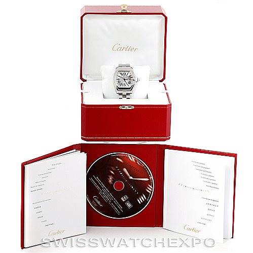 This image shows a Cartier Roadster W62032X6 Men's Stainless Steel Silver Dial W62032X6 Men's Stainless Steel Silver Dial watch with a red display box, instruction manuals, and a CD set.