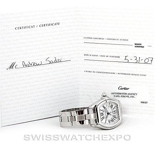 The image shows a Cartier Roadster W62032X6 Men's Stainless Steel Silver Dial W62032X6 Men's Stainless Steel Silver Dial watch at an angle displaying the face and bracelet, along with its certificate and purchase documents.