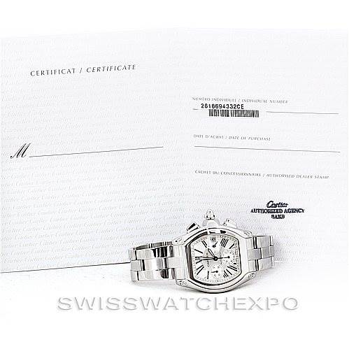 The image shows a Cartier Roadster W62019X6 Men's Stainless Steel Silver Dial W62019X6 Men's Stainless Steel Silver Dial watch placed in front of its certificate, displaying the front view of the watch.