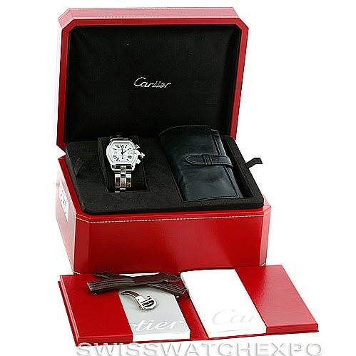 The image shows a Cartier Roadster W62019X6 Men's Stainless Steel Silver Dial W62019X6 Men's Stainless Steel Silver Dial watch in its open case, with additional accessories including a leather pouch and booklets.