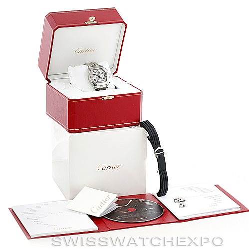 The image shows a Cartier Roadster W62019X6 Men's Stainless Steel Silver Dial W62019X6 Men's Stainless Steel Silver Dial watch at an angle displayed in an open red box with accessories including a black strap, disc, and paperwork.