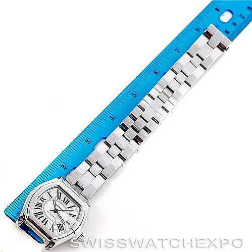 The image shows a Cartier Roadster W62025V3 Men's Stainless Steel Silver Dial W62025V3 Men's Stainless Steel Silver Dial watch laid flat next to a blue ruler, displaying the face and entire bracelet.