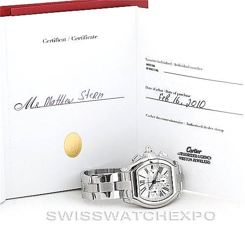 The image shows a Cartier Roadster W62019X6 Men's Stainless Steel Silver Dial W62019X6 Men's Stainless Steel Silver Dial watch displayed next to its opened certificate.