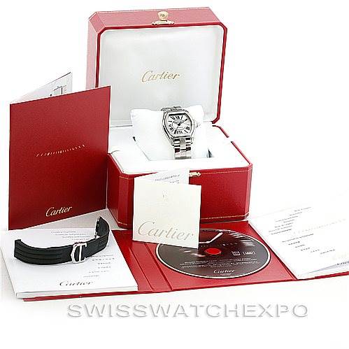 The image shows a Cartier Roadster W62025V3 Men's Stainless Steel Silver Dial W62025V3 Men's Stainless Steel Silver Dial watch with its box, extra strap, booklets, and a CD, all nicely arranged.