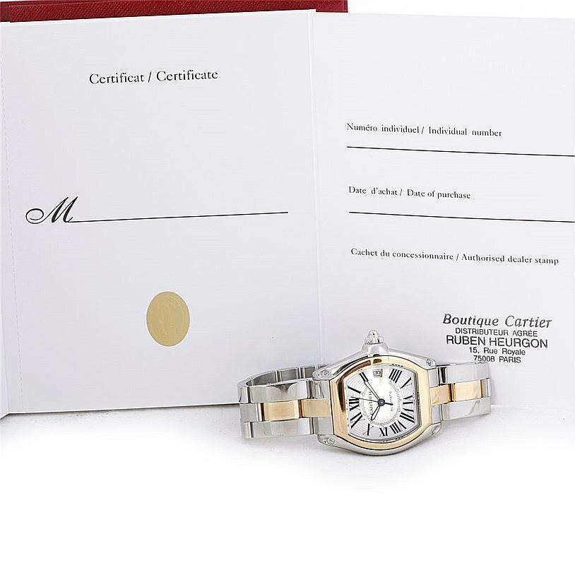 The Cartier Roadster W62031Y4 Men's Steel and Gold (two tone) Silver Dial W62031Y4 Men's Steel and Gold (two tone) Silver Dial watch is displayed with an open warranty certificate on a flat surface.