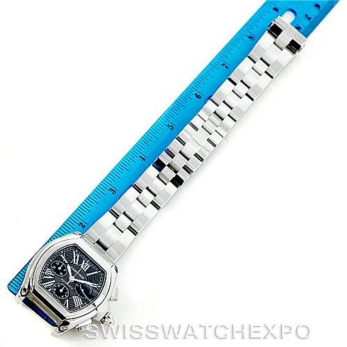 This image shows the front of a Cartier Roadster W62020X6 Men's Stainless Steel Black Dial W62020X6 Men's Stainless Steel Black Dial watch alongside a blue ruler for scale.