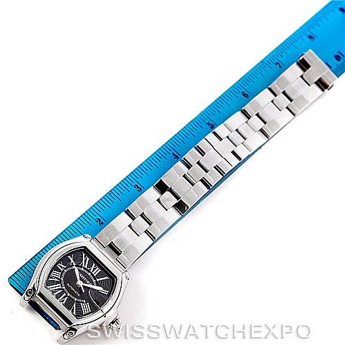 The image shows a Cartier Roadster W62041V3 Men's Stainless Steel Black Dial W62041V3 Men's Stainless Steel Black Dial watch with a metal bracelet next to a blue ruler for scale.