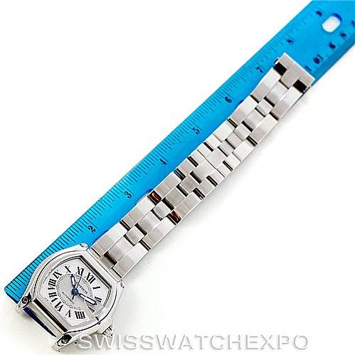 The image shows a top-down angle of a Cartier Roadster W62000V3 Men's Stainless Steel Silver Dial W62000V3 Men's Stainless Steel Silver Dial watch next to a blue ruler.