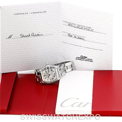 The image shows a Cartier Roadster W62000V3 Men's Stainless Steel Silver Dial W62000V3 Men's Stainless Steel Silver Dial watch at an angle, with its certificates and red presentation folders.