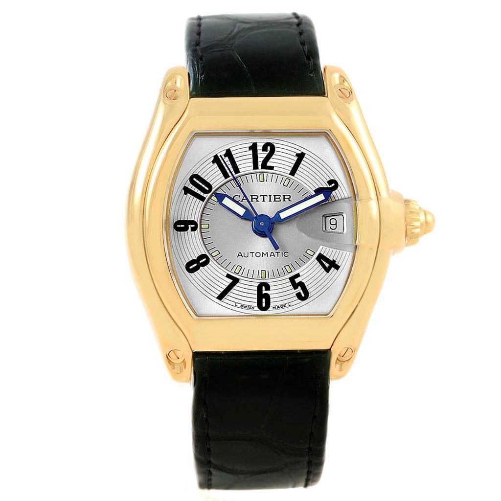 The image shows a frontal view of a Cartier Roadster W62005V2 Men's Yellow Gold Silver Dial W62005V2 Men's Yellow Gold Silver Dial watch, highlighting its dial, bezel, and black leather strap.