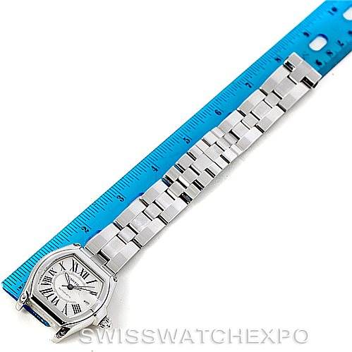 The Cartier Roadster W62025V3 Men's Stainless Steel Silver Dial W62025V3 Men's Stainless Steel Silver Dial watch is shown laid flat, including the face, case, and full bracelet, next to a blue ruler for scale.