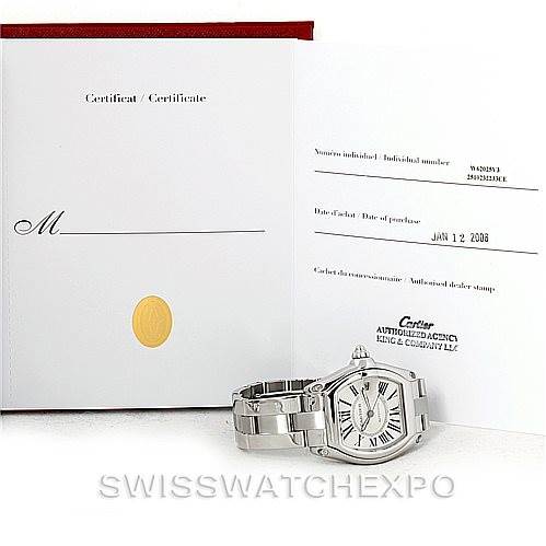 The image shows the Cartier Roadster W62025V3 Men's Stainless Steel Silver Dial W62025V3 Men's Stainless Steel Silver Dial watch with its bracelet alongside its certificate of authenticity.