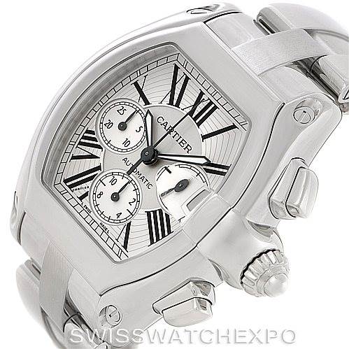 The image shows a close-up of the Cartier Roadster W62019X6 Men's Stainless Steel Silver Dial W62019X6 Men's Stainless Steel Silver Dial watch, highlighting its face, crown, and side buttons at an angle.