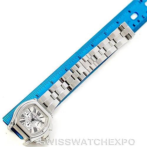 This is a top-down view of a Cartier Roadster W62019X6 Men's Stainless Steel Silver Dial W62019X6 Men's Stainless Steel Silver Dial watch, showcasing the face, bezel, and the full length of the metal bracelet next to a ruler.