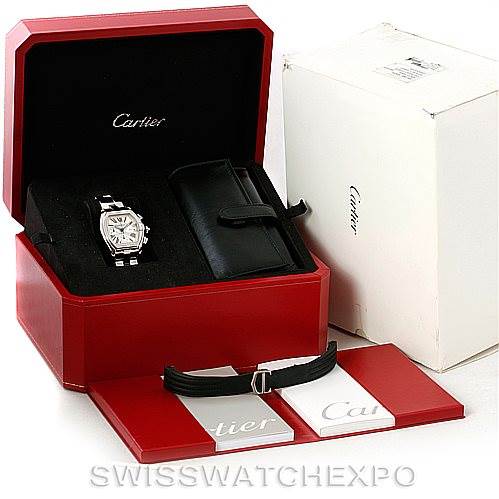 The image shows a Cartier Roadster W62019X6 Men's Stainless Steel Silver Dial W62019X6 Men's Stainless Steel Silver Dial watch with its original red box, additional straps, a black case, and an outer white box.