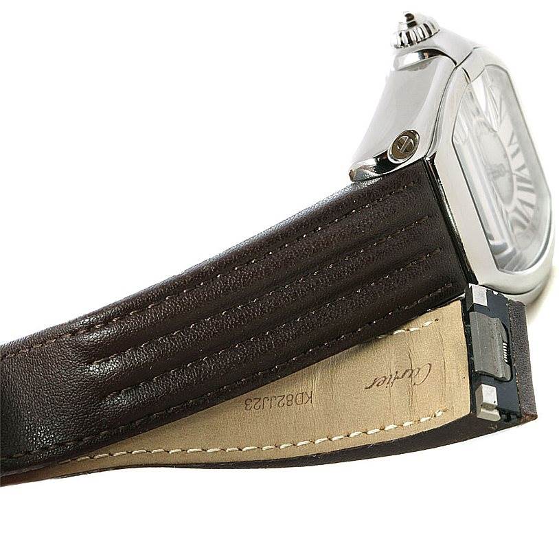 The image shows a side angle of the Cartier Roadster W62032X6 Men's Stainless Steel Silver Dial W62032X6 Men's Stainless Steel Silver Dial watch, highlighting its case, crown, and leather strap.