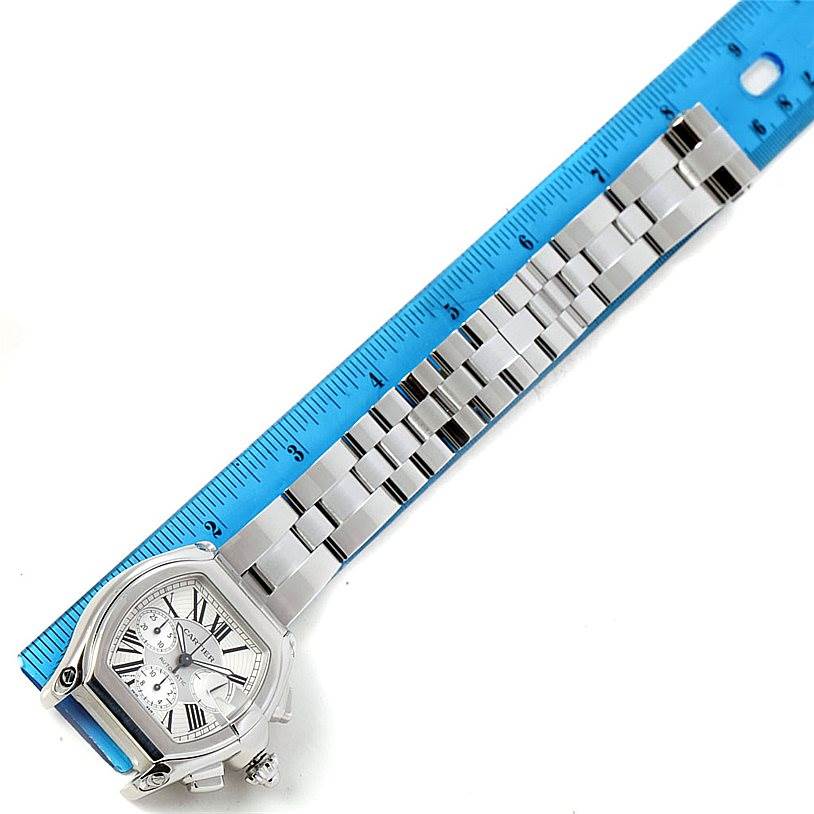 The image shows a Roadster model watch by Cartier laid flat with a blue ruler for measurement.