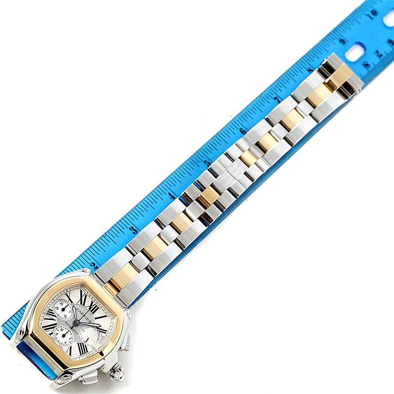 The Cartier Roadster W62027Z1 Men's Steel and Gold (two tone) Silver Dial W62027Z1 Men's Steel and Gold (two tone) Silver Dial watch is shown face-up with the entire bracelet and a ruler for scale.