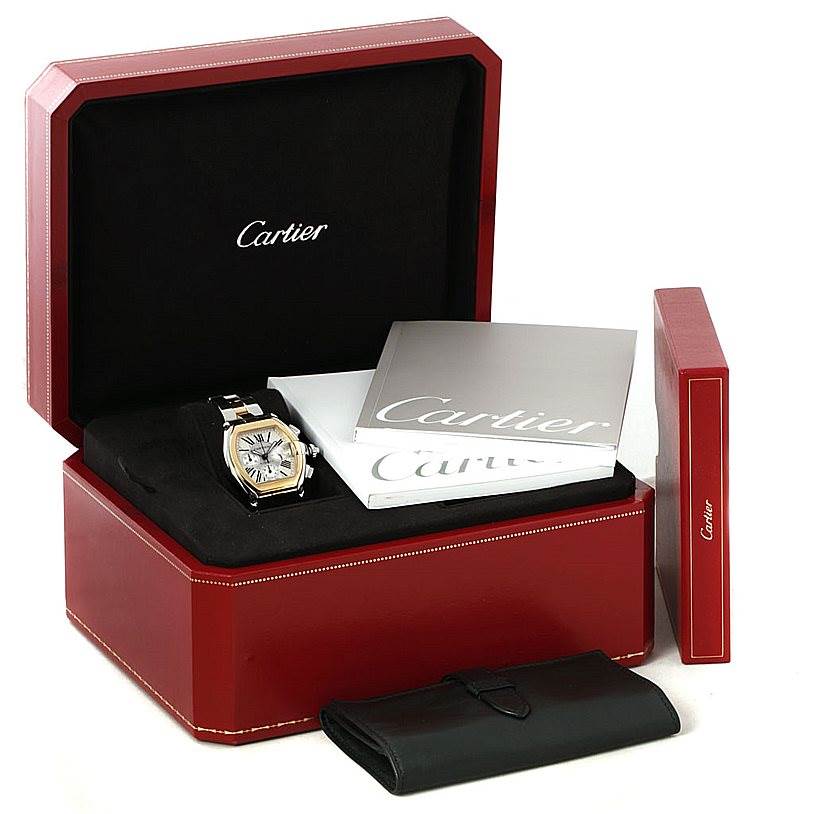 The Cartier Roadster W62027Z1 Men's Steel and Gold (two tone) Silver Dial W62027Z1 Men's Steel and Gold (two tone) Silver Dial watch is shown inside a red watch box with accompanying booklets and a black leather pouch.