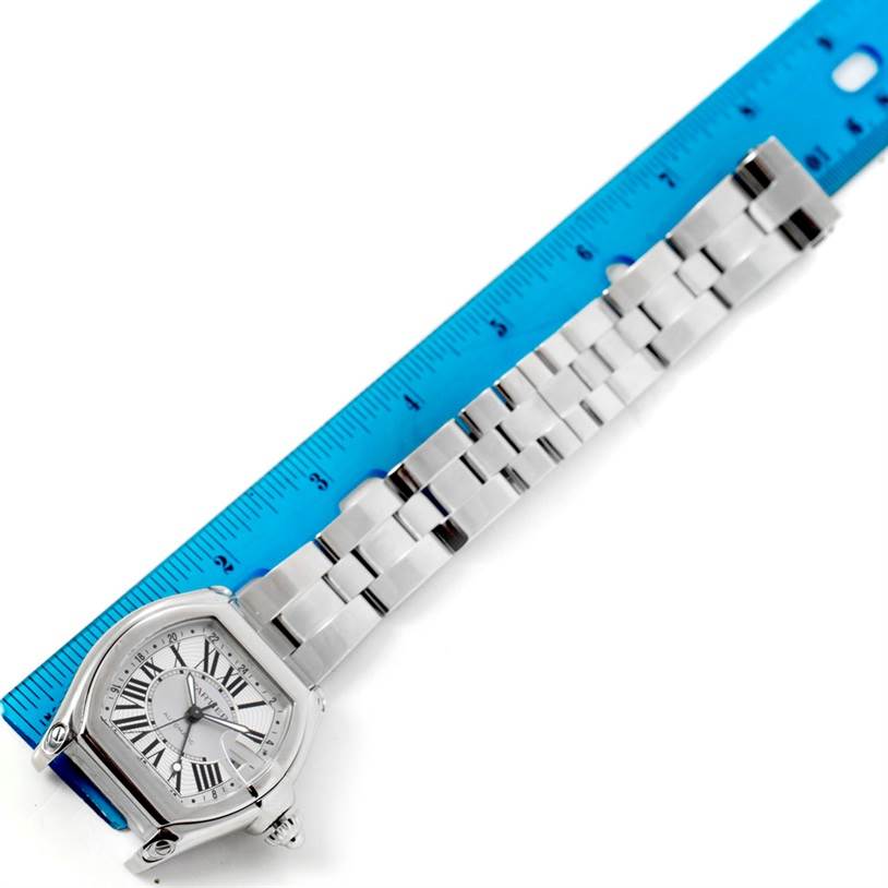 This image shows the face and metal bracelet of the Cartier Roadster W62032X6 Men's Stainless Steel Silver Dial W62032X6 Men's Stainless Steel Silver Dial watch, partially measured against a blue ruler.
