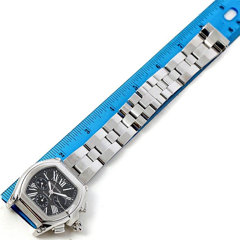 The Cartier Roadster W62020X6 Men's Stainless Steel Black Dial W62020X6 Men's Stainless Steel Black Dial watch is shown from the top, highlighting the face, bracelet, and clasp, with a measuring ruler alongside it.